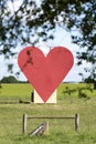 Countryside passion concept, big red heart in the middle of the fields Royalty Free Stock Photo