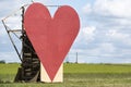 Countryside passion concept, big red heart in the middle of the fields Royalty Free Stock Photo