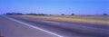 Countryside paved road on hilly landscape covered by meadows and trees, in a sunny day near buenos aires A small rural village