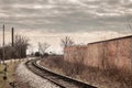 Countryside railway track, on a curve, on a line in Serbia, Europe, rusty, in a rural environment, during a cloudy afternoon