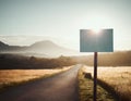 Countryside road ahead and blank defocused sign on the side