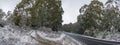 Countryside road with dirt side road in winter Royalty Free Stock Photo