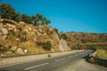 Countryside road passing over hilly landscape on sunset Royalty Free Stock Photo