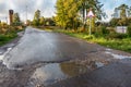 Countryside road. Rut with puddles. Road sign Royalty Free Stock Photo