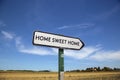 In the countryside a road sign with the inscription home sweet h Royalty Free Stock Photo