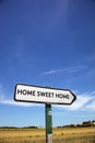 In the countryside a road sign with the inscription home sweet h Royalty Free Stock Photo