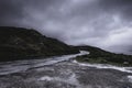 Countryside road wet after rain in scenic mountain valley Royalty Free Stock Photo