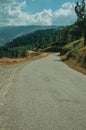 Countryside roadway passing through hilly landscape