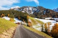 Countryside rural landscape with a country road on a sunny day in late autumn, Val di Funes, Dolomite mountains. Royalty Free Stock Photo