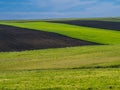 Countryside spring landscape of plowed fields. Green grass and broun ground. Ponidzie. Poland Royalty Free Stock Photo