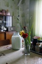 Countryside still life with milk jar and flowers