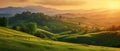 Countryside sunset in green hills of spring fields with old castle farm and mountains on background of evening landscape.