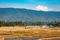 Countryside tarnish framing rice field with mountain background and blue sky at morning