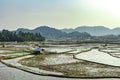 Countryside tarnish framing rice field with small resting huts at morning