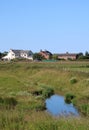 Countryside view, stream, brick houses, meadows Royalty Free Stock Photo