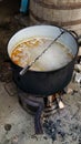 Countryside wood burning big cast iron pot. Outdoor pottage cooking traditional cuisine meatballs soup Royalty Free Stock Photo