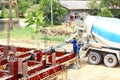 The countryside worker and labor working in construction site. they work with concrete mixer truck amd put concrete into cement