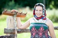 Countrywoman holding wooden rake