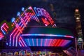 County Fair carnival ride lights of red and blue from outside Royalty Free Stock Photo