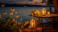 county table with candle lanterns and flowers by the lake