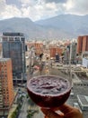 Cup of Spanish drink cocktail sangria overlooking Caracas city with famous El Avila mountain in the backgound