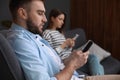 Couple addicted to smartphones ignoring each other at home Royalty Free Stock Photo
