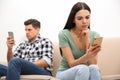 Couple addicted to smartphones ignoring each other at home. Relationship problems Royalty Free Stock Photo