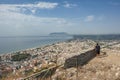 A couple admire the panoramic view of Terracina, Latina Italy . Beautiful seascape with Circeo promontory in the background