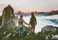 Couple adventurers hands holding traveling in Norway