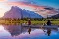 Couple adventurous friends are canoeing in a lake surrounded by the Canadian Mountains. Royalty Free Stock Photo