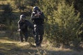 Couple of Airsoft soldiers shooting