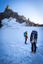 Couple alpinists mountaineers walking glacier slopes. Mont Blanc