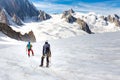 Couple alpinists mountaineers walking glacier slopes. Mont Blanc