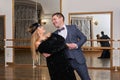 Couple of amateur dancers dancing tango with each other and laughing Royalty Free Stock Photo