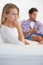 Couple, angry and living room couch with anger, upset and thinking with disagreement fight or mad. Divorce, betrayal and