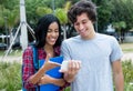 Couple aof young adults watching movie on mobile phone