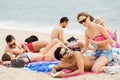 Couple applying suntan lotion and smiling