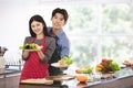 Couple in apron make salad rolls together Royalty Free Stock Photo