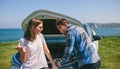 Couple argue while fix their broken down car Royalty Free Stock Photo