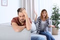 Couple arguing in living room. Royalty Free Stock Photo