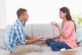 Couple arguing while sitting on sofa Royalty Free Stock Photo