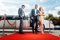 Couple arriving with limousine walking red carpet Royalty Free Stock Photo