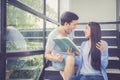 Couple asian handsome man and beautiful woman reading book and glad at home. Royalty Free Stock Photo