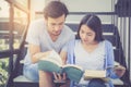 Couple asian handsome man and beautiful woman reading book and smile Royalty Free Stock Photo