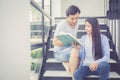 Couple asian handsome man and beautiful woman reading book and smile Royalty Free Stock Photo