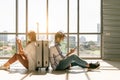 Couple asian traveler looking smartphone and sit waiting for flight at airport terminal Royalty Free Stock Photo