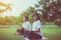 Couple asian woman practicing yoga at park in the morning,Happy and smiling,Positive thinking,Healthy and lifestyle concept