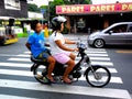 Couple of asian women riding a motorcycle