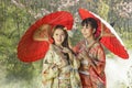 Couple asian women wearing traditional japanese kimono and red u Royalty Free Stock Photo