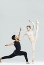 Couple of Asian Young Man and Caucasian Woman As Ballet Dancers Over Grey in Studio During Suppots As Classical Dance With Royalty Free Stock Photo